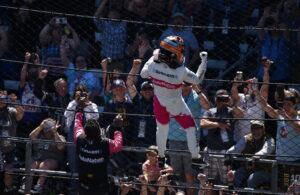 After winning the 105th Indianapolis 500, Helio Castroneves scaled the catchfence. (Photo: Luis Torres/The Podium Finish)