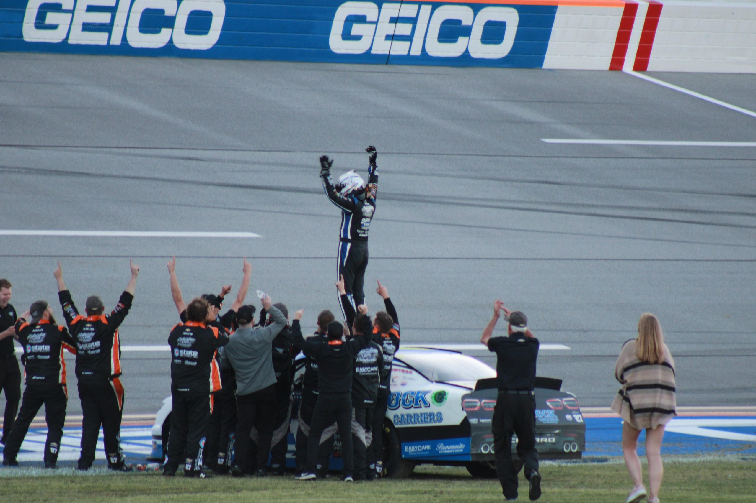 It was arms raised in victory for Burton with his No. 27 team. (Photo: Trish McCormack | The Podium Finish)