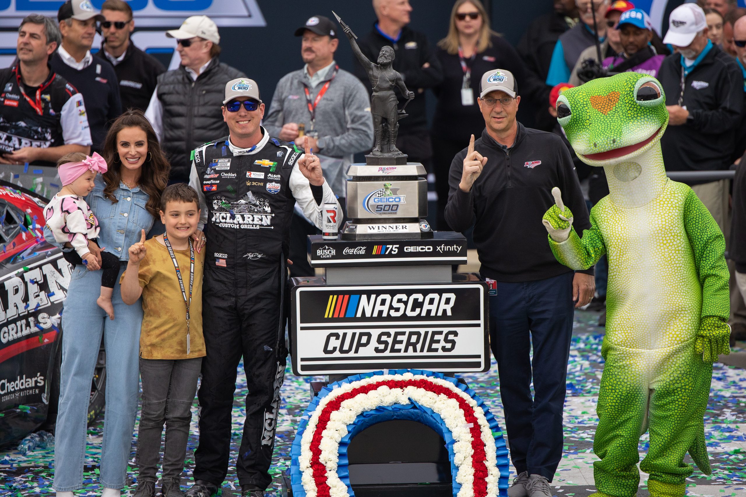 Busch and his family, and Martin the GEICO gecko bask in a win in the Yellowhammer State. (Photo: Riley Thompson | The Podium Finish)