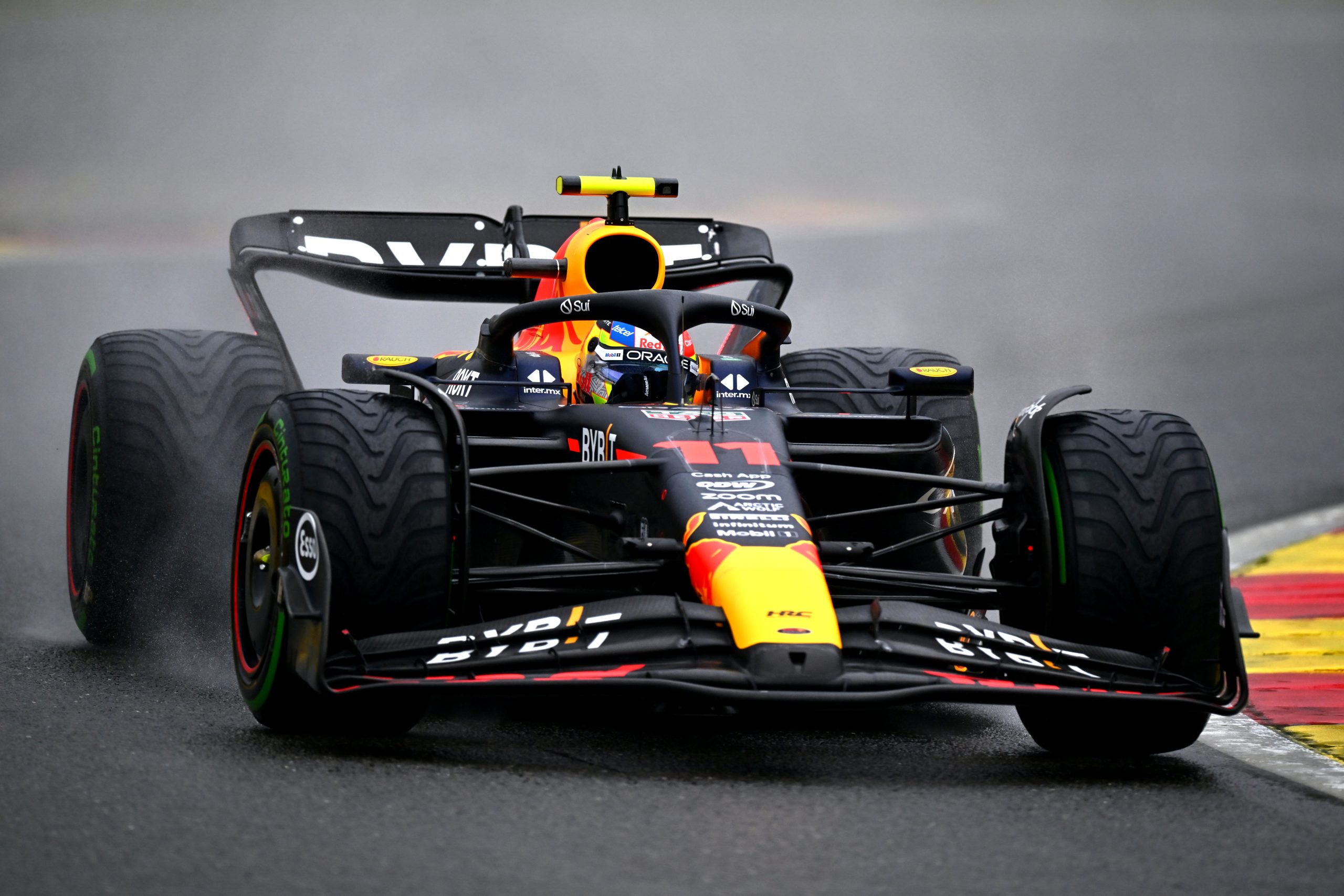 Sergio Perez (11) on a wet track in his Red Bull for the Belgium Grand Prix