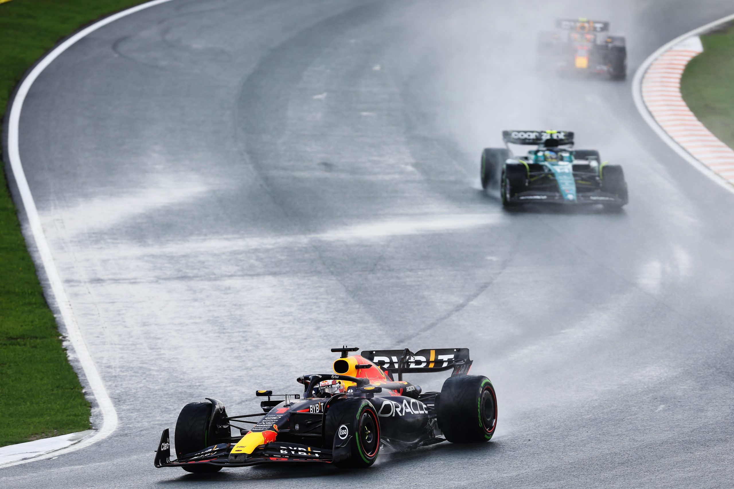 Max Verstappen (1) leads in his Red Bull over Fernando Alonso (14) and Red Bull teammate Sergio Perez (11) in the closing stages of the Dutch Grand Prix at the Circuit Zandvoort.