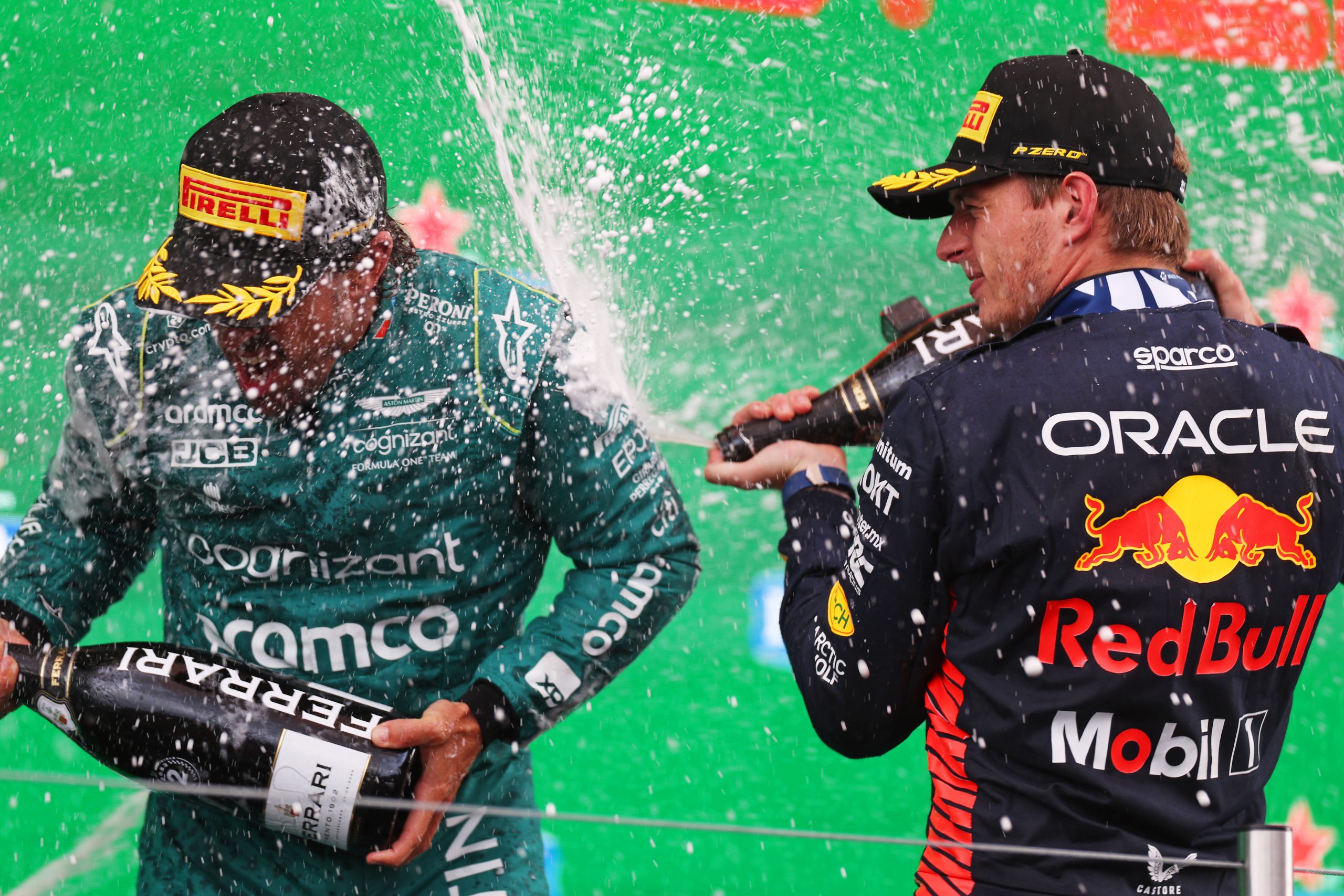 Max Verstappen (1) sprays champagne on Fernando Alonso following his win at the Circuit Zandvoort for the Dutch Grand Prix, his 11th win of the season and 9th in a row.