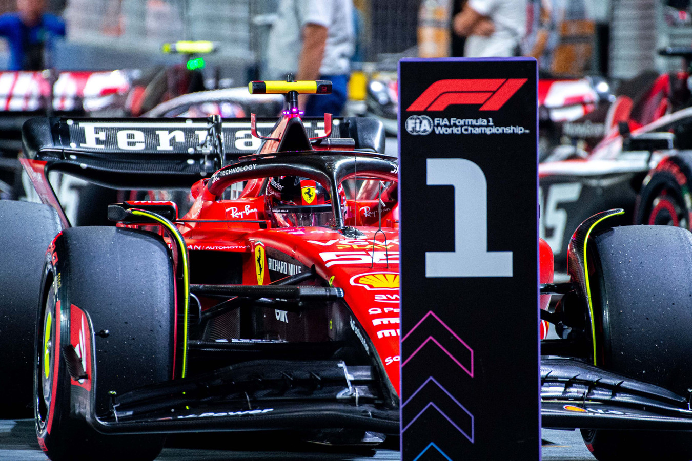 Carlos Sainz (55) parks at the #1 pit board after securing the pole position for Ferrari at the Marina Bay Street Circuit for the Formula 1 Singapore Grand Prix