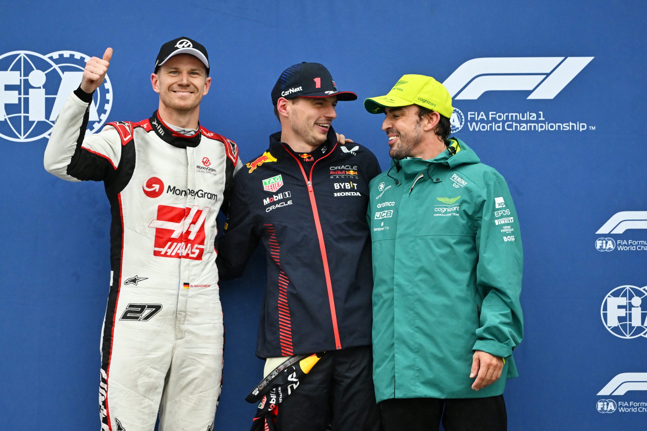 Pole position qualifier Max Verstappen of the Netherlands and Oracle Red Bull Racing (C), Second placed qualifier Nico Hulkenberg of Germany and Haas F1 (L) and Third placed qualifier Fernando Alonso of Spain and Aston Martin F1 Team (R) pose for a photo in the Pitlane during qualifying ahead of the F1 Grand Prix of Canada at Circuit Gilles Villeneuve on June 17, 2023 in Montreal, Quebec. (Photo by Dan Mullan/Getty Images)