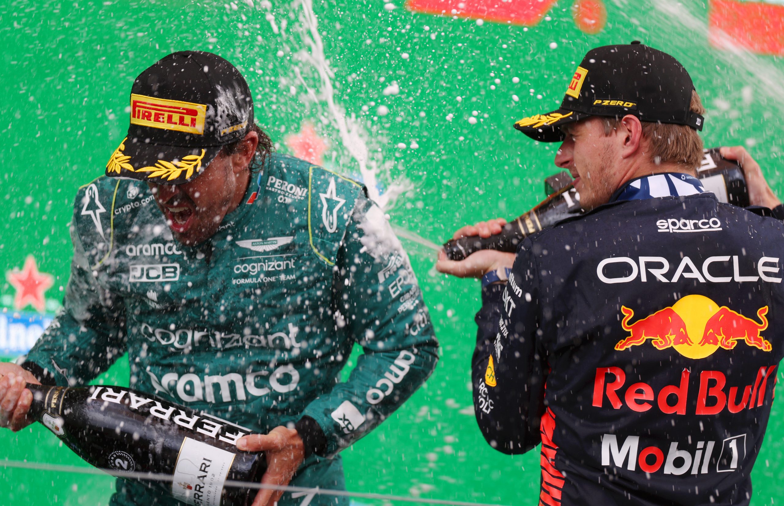 Race winner Max Verstappen of the Netherlands and Oracle Red Bull Racing and Second placed Fernando Alonso of Spain and Aston Martin F1 Team celebrate on the podium during the F1 Grand Prix of The Netherlands at Circuit Zandvoort on August 27, 2023 in Zandvoort, Netherlands. (Photo by Dean Mouhtaropoulos/Getty Images) *** BESTPIX ***