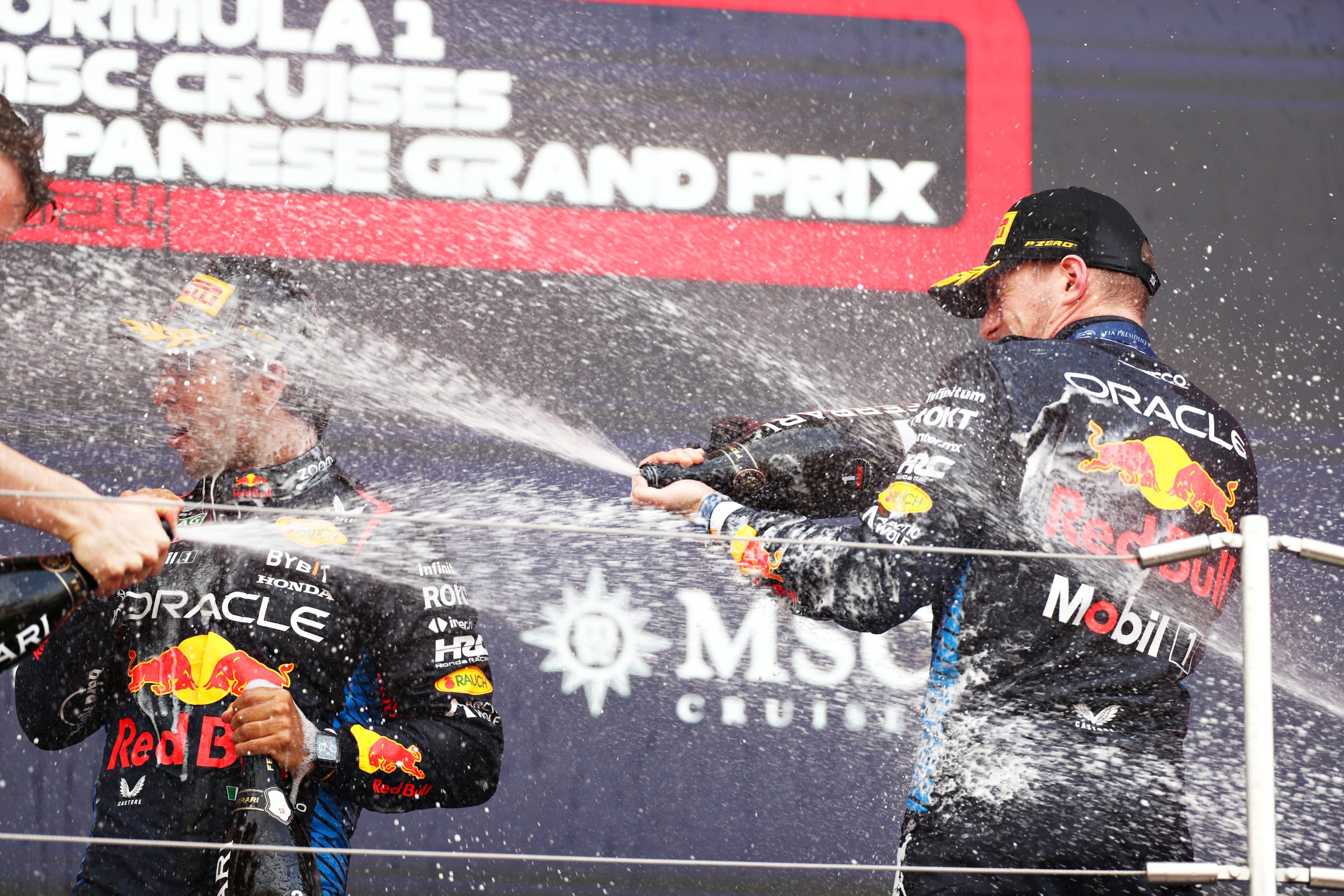 Race winner Max Verstappen of the Netherlands and Oracle Red Bull Racing and Second placed Sergio Perez of Mexico and Oracle Red Bull Racing celebrate on the podium during the F1 Grand Prix of Japan at Suzuka International Racing Course on April 07, 2024 in Suzuka, Japan. (Photo by Peter Fox/Getty Images)