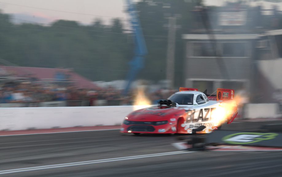 Buddy Hull and his Blaze Exhaust Probes Dodge Funny Car power down the track at the NHRA New England Nationals on Friday.
