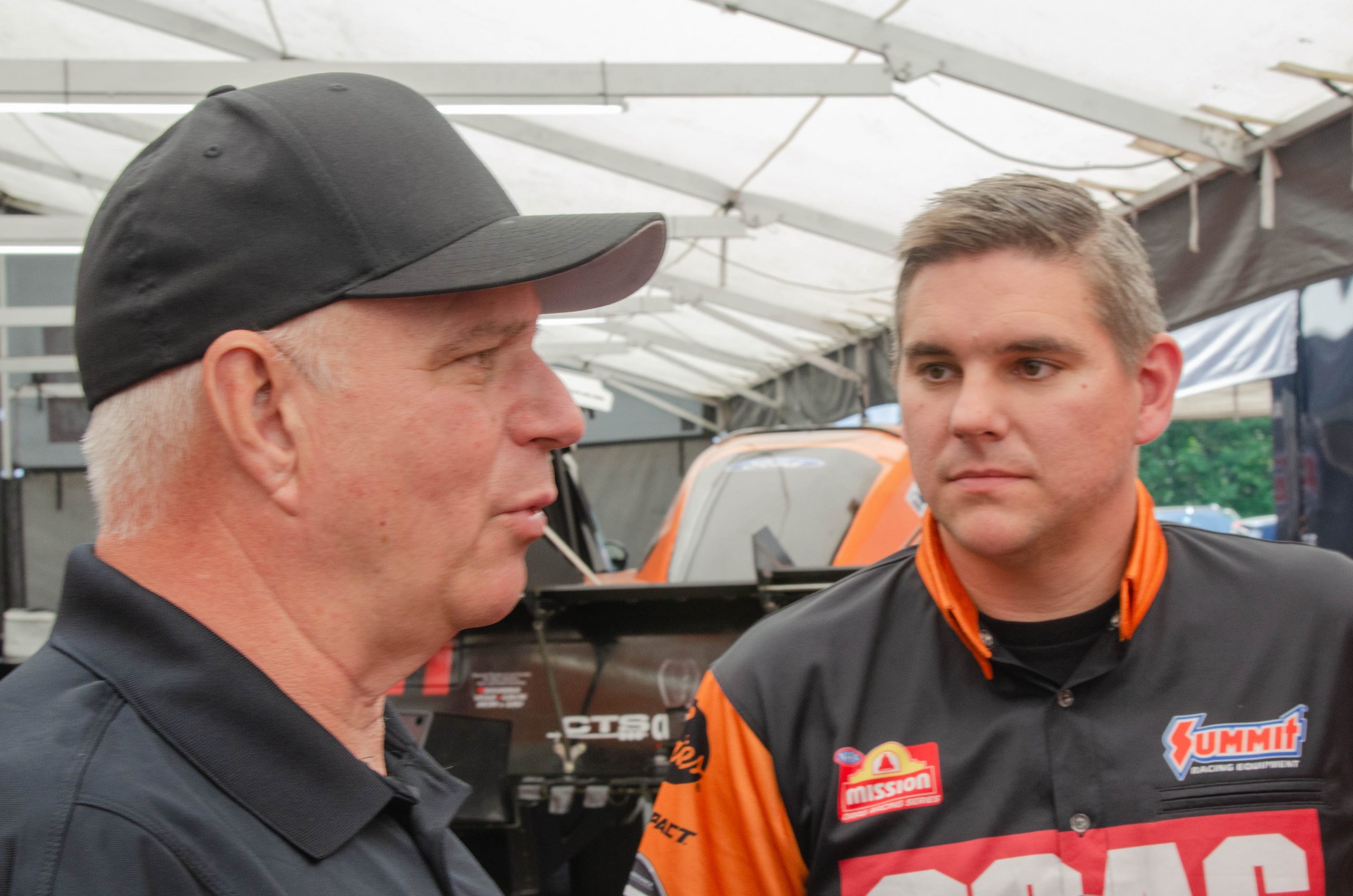 Tim and Dan Wilkerson compare notes during the NHRA New England Nationals at Epping, New Hampshire.