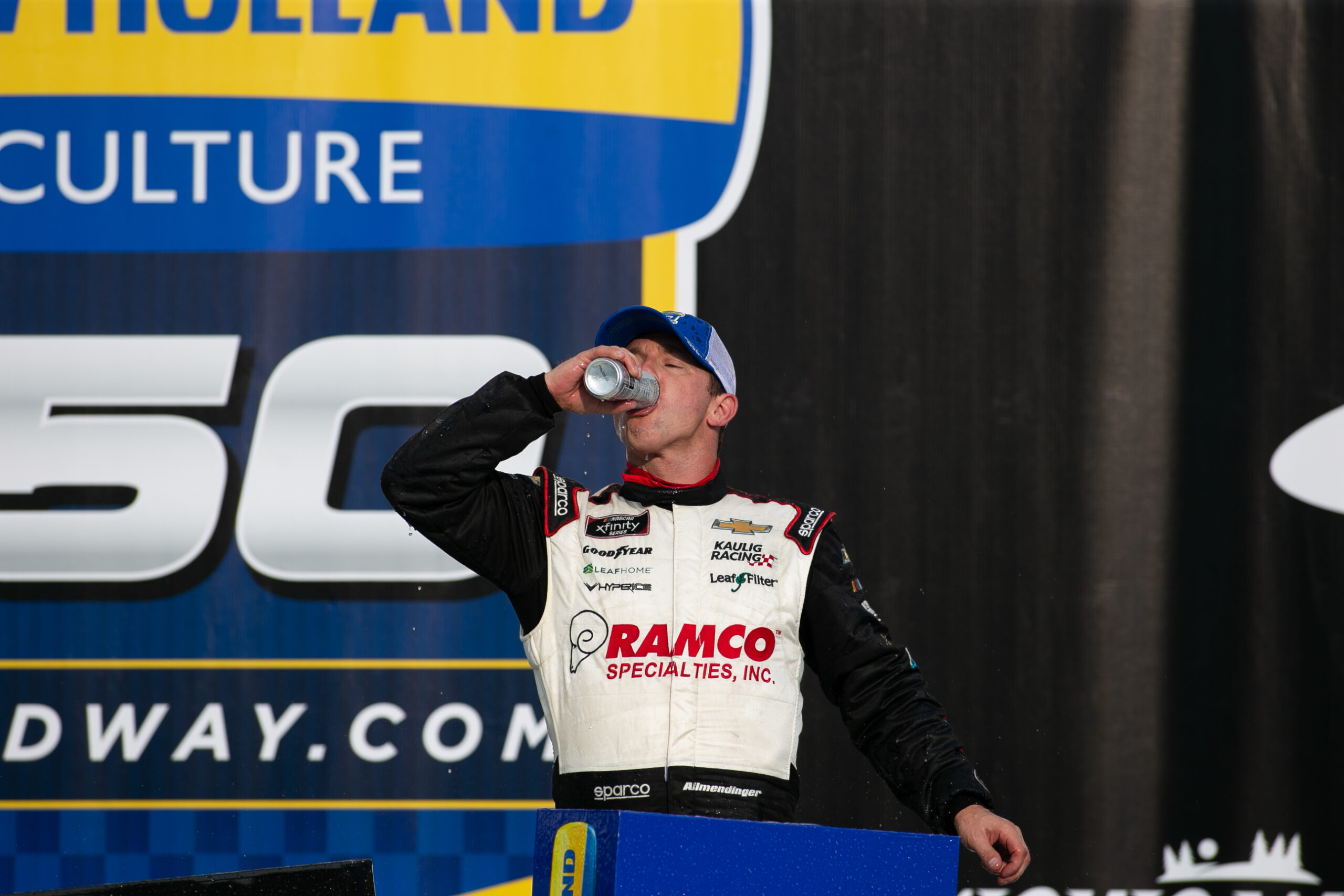 AJ Allmendinger celebrates in victory lane at Michigan International Speedway.