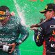 Max Verstappen (1) sprays champagne on Fernando Alonso following his win at the Circuit Zandvoort for the Dutch Grand Prix, his 11th win of the season and 9th in a row.