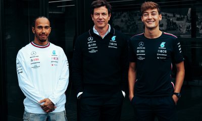 Toto Wolff stands with Lewis Hamilton and George Russell following the announcement that both will be staying at Mercedes through at least 2025