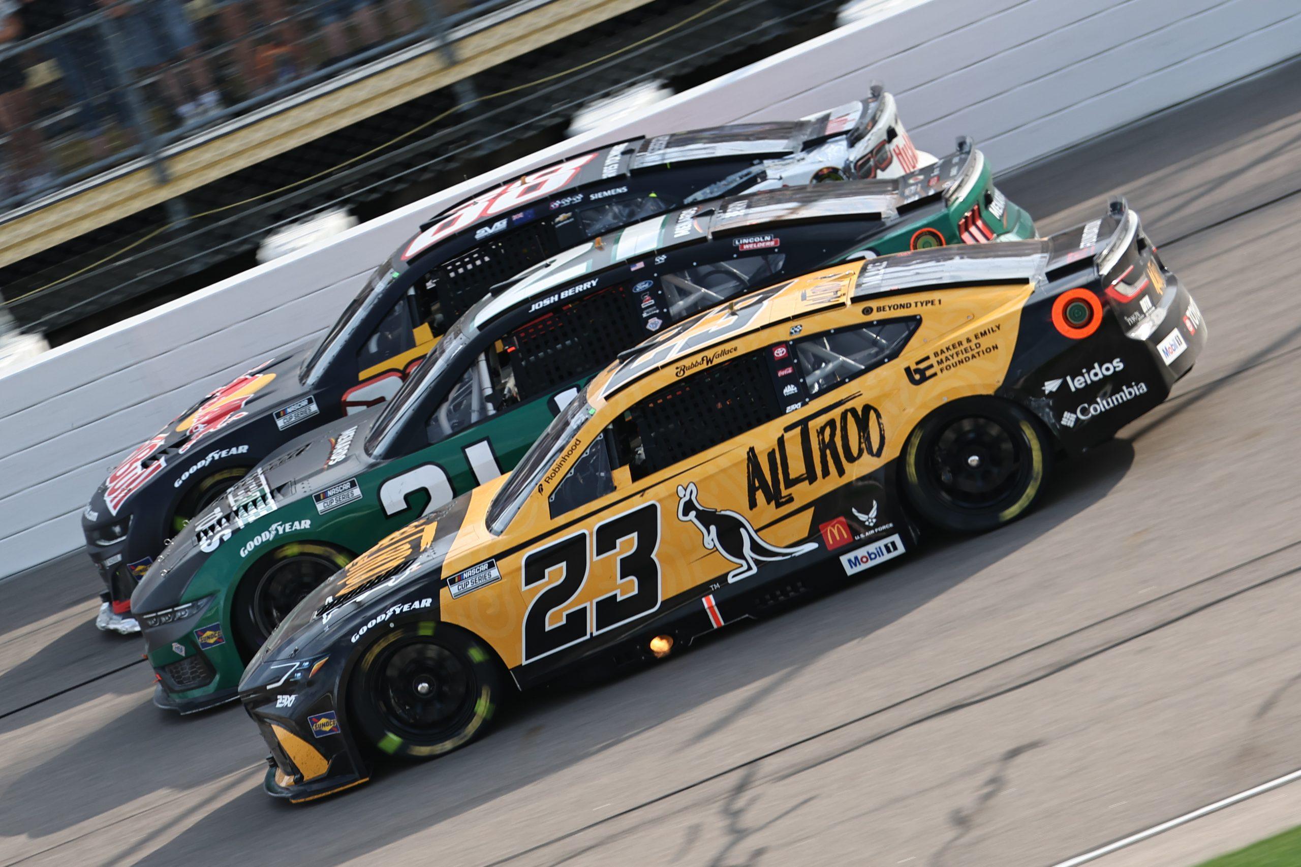 Bubba Wallace (front) battle with future NASCAR Cup Series Playoff competitors Josh Berry (middle) and Shane Van Gisbergen (back) for position during the Iowa Corn 350 at Iowa Speedway.