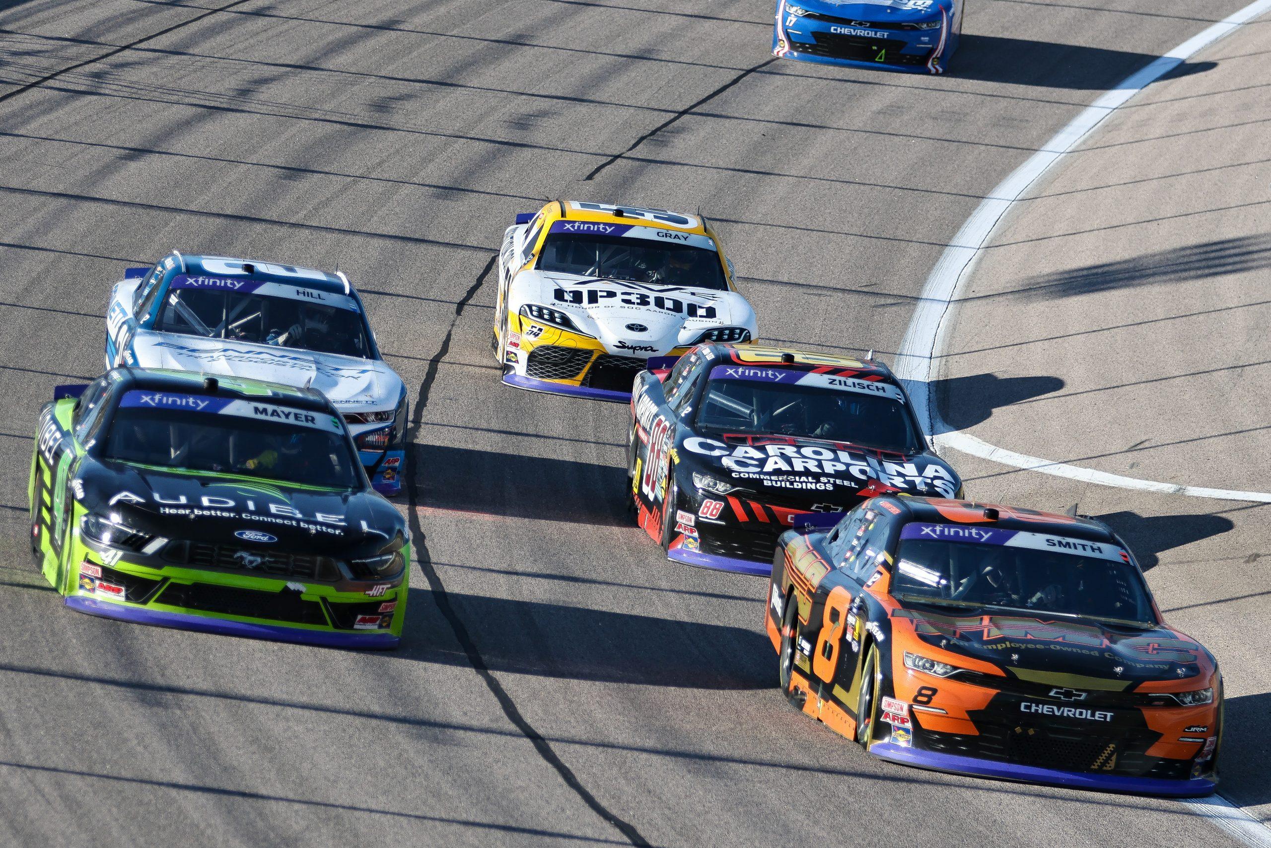 Sammy Smith (right) continues to fight with Sam Mayer (left), Connor Zilisch and Austin Hill (behind) during the Kansas Lottery 300 at Kansas Speedway.