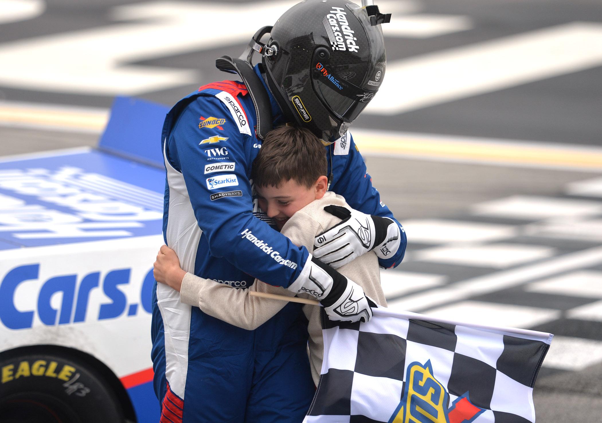Kyle Busch celebrating with Brexton Busch after winning the Fr8 Racing 208 from EchoPark Speedway.