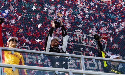 Kyle Kirkwood celebrates on the podium after taking the victor in the Java House Grand Prix of Arlington (Photo: Hannah Pattillo | The Podium Finish).