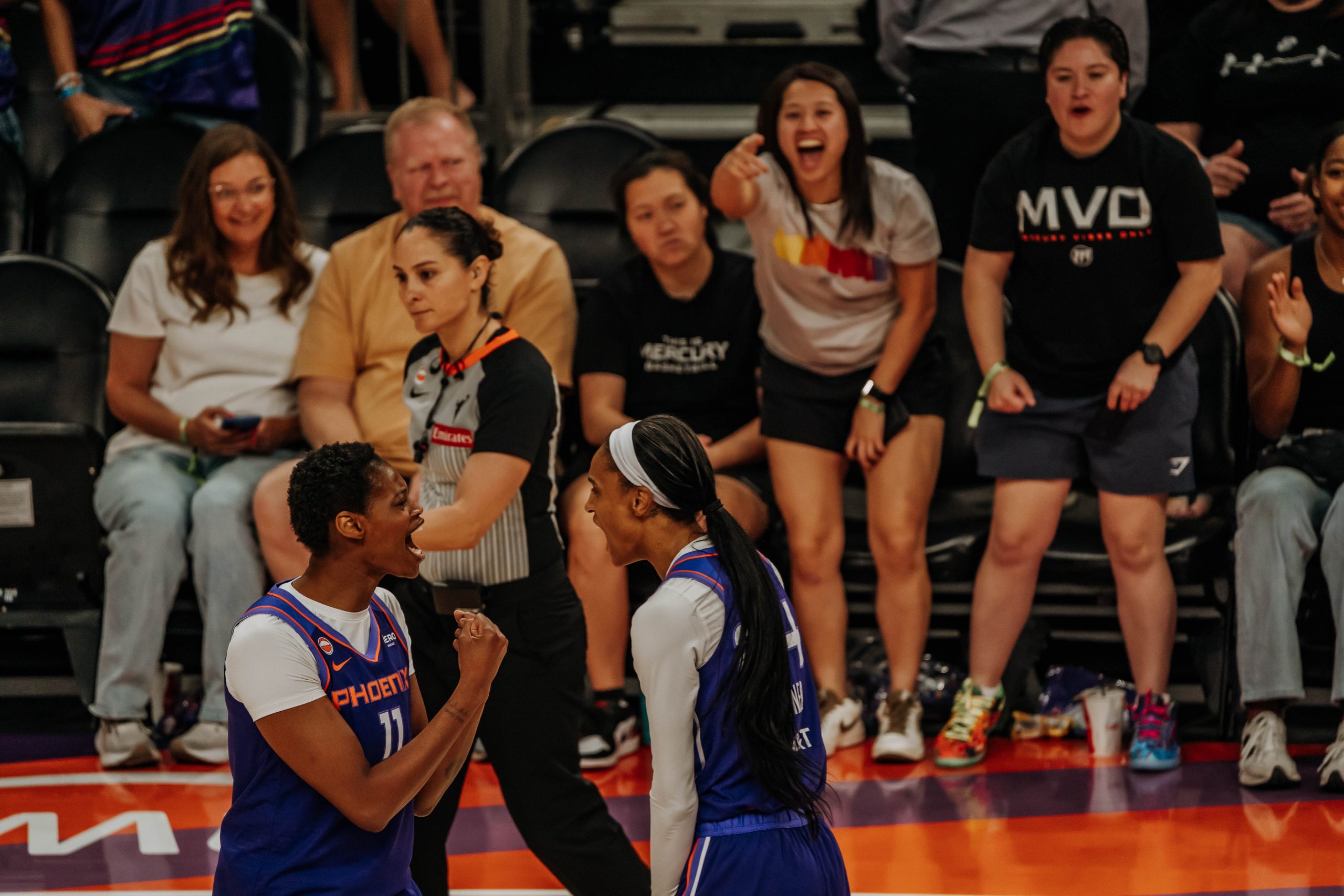 Phoenix Mercury forwards Valeriane Ayayi (No. 11) and DeWanna Bonner (No. 24) celebrate during a matchup against the Seattle Storm. (Photo- Adrianna Peralta, Trippy Traveler Media)