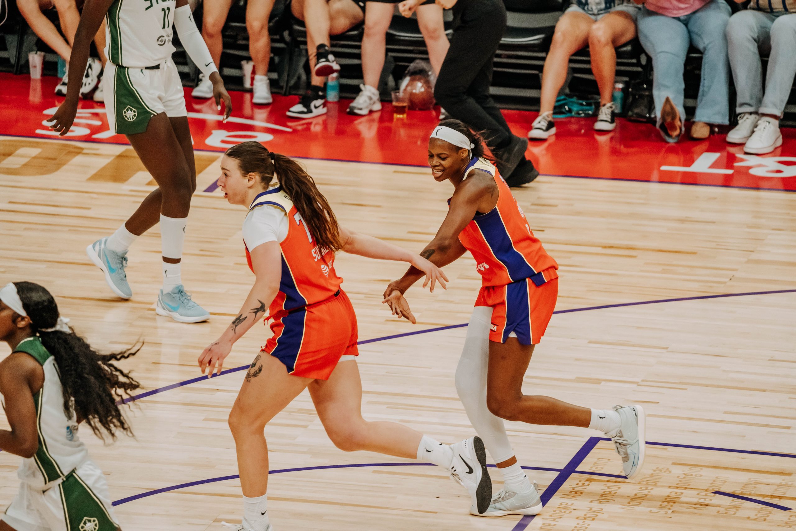 Phoenix Mercury forward Marta Suarez (No. 77) high fives forward Valeriane Ayayi (No. 11) during home game against the Seattle Storm on July 2. Photo- Adrianna Peralta, The Podium Finish)